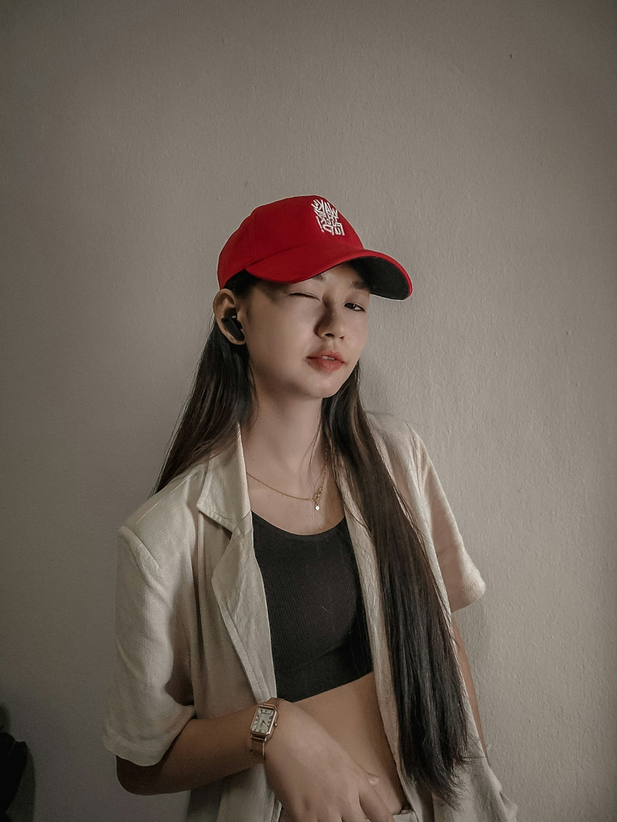 a woman with long hair wearing a red hat