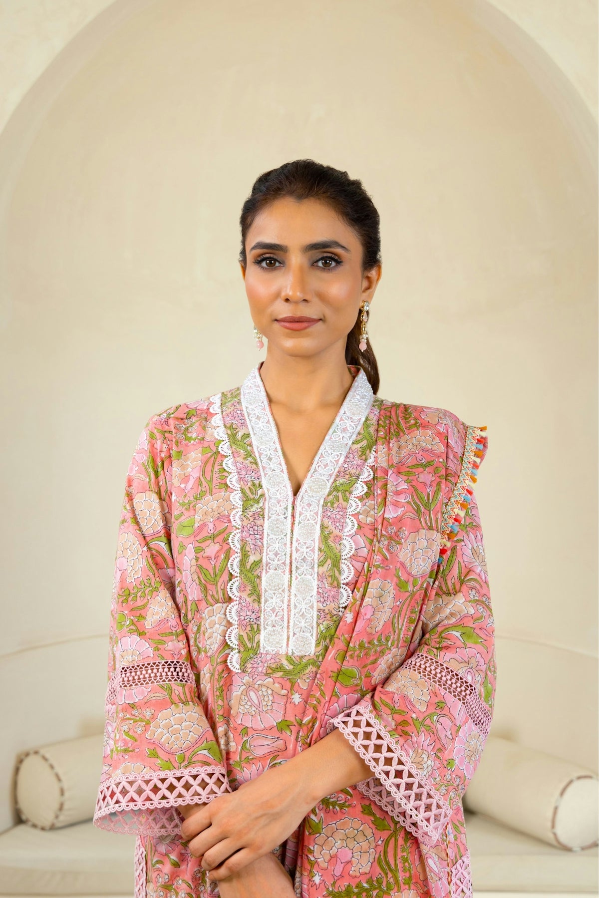 A woman standing in front of a white couch